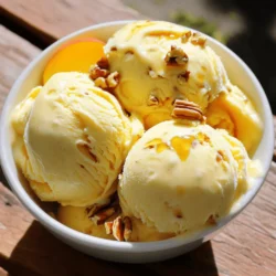 To make homemade peach ice cream, you need a few key items: - 4 ripe peaches, pitted and diced - 1 cup heavy cream - 1 cup whole milk - ¾ cup granulated sugar - 1 teaspoon pure vanilla extract - ½ teaspoon sea salt - 1 tablespoon freshly squeezed lemon juice These basic ingredients give your ice cream a creamy, dreamy texture. The heavy cream and whole milk create a rich base. The sugar adds sweetness, while the lemon juice enhances the peach flavor. Using fresh peaches makes a big difference. They should be ripe, juicy, and fragrant. Fresh peaches bring natural sweetness and a vibrant flavor to your ice cream. When you blend them, they create a smooth, fruity base that sings of summer. If you use canned peaches, the taste will not be the same. Canned peaches can be mushy and overly sweet. Fresh peaches provide the best texture and flavor for your homemade ice cream. You can get creative with your peach ice cream. Here are some optional ingredients to consider: - Chopped pecans or almonds for garnish - A splash of bourbon for a grown-up twist - A swirl of caramel or chocolate sauce - Fresh mint leaves for added color and flavor These extras can enhance your ice cream, adding crunch or a unique taste. Feel free to experiment and find what you love best! For the complete recipe, check the Full Recipe. To start, you need ripe peaches. Choose ones that smell sweet and feel soft. Slice the peaches, then remove the pits. Dice them into small pieces. This will help them mix better in the ice cream. Place the diced peaches in a bowl. Add about ⅜ cup of sugar. Toss the peaches gently to coat them. Let them sit for 30 minutes. This step draws out the juices and boosts the flavor. You will notice the peaches become syrupy. This syrup makes your ice cream taste amazing. Next, you need to make the cream base. In a large bowl, whisk together 1 cup of heavy cream and 1 cup of whole milk. Add the remaining ⅜ cup of sugar, 1 teaspoon of vanilla extract, and ½ teaspoon of sea salt. Whisk until the sugar dissolves and everything mixes well. This base is rich and creamy. It will balance the sweetness of the peaches. Now comes the fun part—churning the ice cream! Pour the cream mixture into your ice cream maker. Turn it on and let it churn for about 20 to 25 minutes. You want it to get thick and creamy. If you don’t have an ice cream maker, you can use a large bowl and a whisk. Whisk every 30 minutes until it reaches a thick texture. Once done, transfer the ice cream to an airtight container. For a firmer texture, freeze it for 2 to 4 hours. When it is ready, scoop it into bowls. Enjoy your homemade peach ice cream! Check the Full Recipe if you want more details. To get the best texture and flavor in your peach ice cream, always use ripe peaches. Ripe peaches are sweet and juicy. They give your ice cream that fresh taste. When you macerate the peaches, let them sit for 30 minutes. This step brings out their natural juices. You want to blend the peaches until smooth, but keep some small chunks for texture. If your ice cream is too hard, it may need more time to churn. Make sure to follow the manufacturer’s directions for your ice cream maker. If the ice cream is icy, it might not have enough fat. Use heavy cream and whole milk for a creamy base. If it tastes too sweet, add a bit more lemon juice to balance it out. For the best peach ice cream, use a good ice cream maker. A quality machine churns the mix well and adds air. This air makes the ice cream creamy and light. A blender or food processor is also important for blending the peaches. Invest in a sturdy mixing bowl and whisk for mixing the cream base. For serving, have ice cream scoops ready. You want to serve it perfectly every time. For the full recipe, check out the details above. {{image_4}} You can make peach ice cream without dairy. Use coconut milk or almond milk instead of cream and milk. These options keep the flavor bright and creamy. You can also use a plant-based cream. This helps add richness. Sweeten with agave or maple syrup for a vegan treat. Blend ripe peaches with these alternatives to enjoy a luscious, dairy-free delight. Mix-ins can add fun twists to your peach ice cream. Try adding crushed cookies or chocolate chips for a crunchy texture. You can also stir in fresh berries for a fruity explosion. For a spiced kick, add a sprinkle of cinnamon or nutmeg. If you want a tropical vibe, mix in shredded coconut. Each of these options brings new flavors and makes your ice cream unique. Serving peach ice cream can be a fun experience. Use tall glasses for a sundae effect. Layer your ice cream with fresh peach slices and a drizzle of caramel. For a gourmet touch, serve it in a homemade waffle cone. You can also top it with fresh mint leaves for a pop of color. Don't forget to add a side of peach puree for extra flavor. These tips make your dessert not just tasty but also beautiful. For the full recipe, check out the steps above. To keep your homemade peach ice cream fresh, store it in an airtight container. This helps prevent ice crystals from forming. Make sure the container is freezer-safe. You can also cover the ice cream with plastic wrap before sealing the lid. This extra layer keeps air out and flavor in. Homemade peach ice cream lasts about 2 to 3 weeks in the freezer. The texture might change after that, becoming more icy than creamy. For best quality, try to eat it within this time frame. If you plan to stash it away, freeze it in smaller portions. This way, you can enjoy it without refreezing the entire batch. If your ice cream becomes too hard, let it sit at room temperature for a few minutes. This softens it, making it easy to scoop. You can also mix it gently with a spoon or spatula to break up any ice crystals. If you want a creamier texture again, try blending it for a few seconds. This refreshes the taste and feel, bringing back that dreamy quality. For fun, add a splash of milk or cream while mixing. This helps restore its smoothness. Check out the Full Recipe for more details on making this delightful treat! When choosing peaches, pick ripe ones. Look for peaches that feel soft but not mushy. The color should be bright, with a hint of red. Smell them; ripe peaches have a sweet aroma. Avoid any with bruises or dark spots. The best peaches will give you a creamy texture and sweet flavor in your ice cream. Yes, you can! If you don't have an ice cream maker, pour the mixture into a shallow dish. Place it in the freezer. Stir it every 30 minutes for about 2-3 hours. This helps break up ice crystals and gives you a smooth texture. It will take a bit longer, but you will still enjoy a delicious treat. You can use coconut cream or evaporated milk as a substitute. Both will give you a creamy texture. If you want a lighter option, use whole milk with a bit of Greek yogurt. This keeps the creaminess while reducing fat. Each option will change the flavor slightly, so choose what you like best. For detailed steps, check out the Full Recipe for Homemade Peach Ice Cream! Making homemade peach ice cream is simple and fun. We covered the right ingredients, like fresh peaches, to boost flavor. You learned step-by-step how to prepare, churn, and create a creamy texture. Tips and tricks helped solve common problems, while variations let you explore dairy-free options and fun add-ins. Always store ice cream properly to keep it fresh. With these insights, you are ready to make a delicious treat. Enjoy your peach ice cream and share it with family and friends!