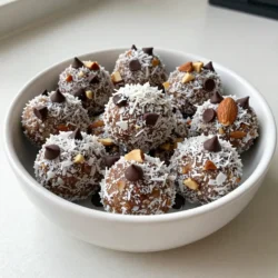 - 1 cup pitted dates - 1 cup unsweetened shredded coconut - 1/2 cup creamy almond butter - 1/2 cup almond flour - 1/2 cup dark chocolate chips (dairy-free if desired) - 1/4 cup chopped almonds - 1 teaspoon pure vanilla extract - A pinch of sea salt Using pitted dates gives these bites a natural sweetness. They also add fiber and energy. Unsweetened shredded coconut brings a rich flavor and texture. It also adds healthy fats. Almond butter is creamy and smooth, providing a good source of protein. Almond flour keeps these bites gluten-free while adding more nutrients. Dark chocolate chips are the perfect treat, and you can use dairy-free options. Chopped almonds add crunch and extra protein. Pure vanilla extract enhances all the flavors, making them pop. A pinch of sea salt balances the sweetness and enhances the taste. Each energy bite offers great nutrition. Here&rsquo;s a breakdown of the key nutrients: - Calories: About 100 per bite - Protein: Around 3 grams - Fat: Roughly 5 grams, mostly healthy fats - Carbohydrates: About 12 grams - Fiber: Approximately 2 grams These bites are a great snack choice. They are full of energy and help you feel full. Plus, they contain no refined sugars, making them a smart pick for health. Enjoy these bites when you need a quick energy boost or a sweet treat! {{ingredient_image_2}} To make your Coconut Almond Joy Energy Bites, start with the right tools. You need a food processor and a baking sheet lined with parchment paper. - First, place the pitted dates, shredded coconut, creamy almond butter, almond flour, vanilla extract, and a pinch of sea salt into the food processor. - Pulse this mix until it blends well and turns sticky. Make sure there are no big pieces of dates left. This blend gives you a great base, packed with natural sweetness and healthy fats. Dates bring energy, while almond butter adds creaminess and protein. Now, it&rsquo;s time to form the bites. - Use a tablespoon to scoop out the mixture. - Roll each scoop into a ball using your hands. Make sure they are about the size of a golf ball. This size is perfect for a quick snack. Once you finish rolling, place each ball on your prepared baking sheet. Space them out so they don&rsquo;t touch. To get the right texture, chill the energy bites. - Put the baking sheet in the refrigerator for at least 30 minutes. This helps them firm up and makes them easier to eat. When you&rsquo;re ready to serve, consider a decorative bowl. You can add a sprinkle of shredded coconut on top for a fun look. These bites make a great snack, full of flavor and energy. Enjoy them anytime you need a boost! You can easily change flavors in your energy bites. For a tropical twist, add pineapple or mango bits. Want more crunch? Toss in chia seeds or sunflower seeds. Different nut butters work well too. Use cashew or peanut butter if you prefer. You can also switch up the chocolate. Try white chocolate or even carob chips for a fun surprise. Store your energy bites in an airtight container. Keep them in the fridge to stay fresh. This helps maintain their texture and flavor. If you want them to last longer, freeze them. Just place them in a freezer-safe bag. They stay good for up to three months in the freezer. Need to swap some ingredients? No problem! If you don&rsquo;t have almond butter, use sunflower seed butter. If you want a nut-free version, use pumpkin seed butter. For a different sweetener, try maple syrup or agave nectar. Just remember to adjust the amount of dry ingredients if you do. This keeps the right texture for your bites. Pro Tips Use Fresh Dates: For the best flavor and texture, opt for fresh, soft pitted dates to ensure your energy bites are sweet and sticky. Customize Your Nuts: Feel free to mix in different nuts or seeds according to your taste preferences&mdash;walnuts, pecans, or sunflower seeds work great! Experiment with Flavors: Add spices like cinnamon or nutmeg to the mixture for a unique flavor boost that complements the coconut and chocolate. Storage Tips: Store the energy bites in an airtight container in the fridge for up to a week, or freeze them for longer-lasting snacks. {{image_4}} You can easily add different flavors to your Coconut Almond Joy Energy Bites. Consider adding a pinch of cinnamon for warmth. A few drops of almond extract can boost the almond taste. You might also try adding dried fruits, like cranberries or apricots, for a chewy twist. If you love spices, a dash of nutmeg can add depth. If you want to change the sweetness level, you have options. Maple syrup or agave can replace pitted dates. Just use less, as they are sweeter. Honey is another great choice for sweetness. Remember, if you use liquid sweeteners, balance it with a little extra almond flour to keep the texture. These energy bites are already vegan and gluten-free, but you can tweak them further. Use coconut flour instead of almond flour for a nut-free option. For sweeteners, choose maple syrup or agave to keep it vegan. Make sure your chocolate chips are dairy-free to keep them vegan-friendly. Always check labels for gluten-free certification if needed. To keep your Coconut Almond Joy Energy Bites fresh, store them in an airtight container. This helps keep moisture out. Place the container in the fridge. The cool temperature helps maintain the bites' flavor and texture. You can also layer parchment paper between the bites to prevent sticking. If you want to save some bites for later, freezing is a great option. Place the energy bites in a single layer on a baking sheet. Freeze them for about an hour. Once firm, transfer them to a freezer-safe bag or container. Label the bag with the date. They can last up to three months in the freezer. Just thaw them in the fridge before enjoying. When stored properly in the fridge, these energy bites last about one week. If you freeze them, you can enjoy them for several months. This makes them a perfect snack for busy days or meal prep. Keeping track of the dates helps ensure you enjoy them at their best! Yes, you can use other nut butters in these energy bites. Almond butter gives a rich flavor. Peanut butter works well too, but it changes the taste. Cashew butter offers a creamy texture with a mild taste. Always choose a nut butter you enjoy. This keeps the energy bites tasty and fun! To make these energy bites healthier, consider these tips: - Use unsweetened cocoa powder instead of chocolate chips. - Add extra nuts or seeds for more fiber. - Swap out some almond flour for ground oats. - Reduce the amount of sweetener if you can. These changes keep the bites nutritious while still delicious. If you don't have pitted dates, try dried figs or prunes as substitutes. Both provide natural sweetness and a sticky texture. You can also use applesauce for moisture, but it may change the texture a bit. Adjust the amount to keep your energy bites firm. This way, you can still enjoy them! In this article, we explored the key ingredients and step-by-step instructions for making energy bites. You learned how to customize your recipes, store them properly, and enjoy tasty variations. Keep in mind that you can easily adapt these bites to fit your needs. Making these treats can be fun, healthy, and fulfilling. With a few simple steps, you can create quick snacks anytime. I hope you feel inspired to try making your own energy bites today!